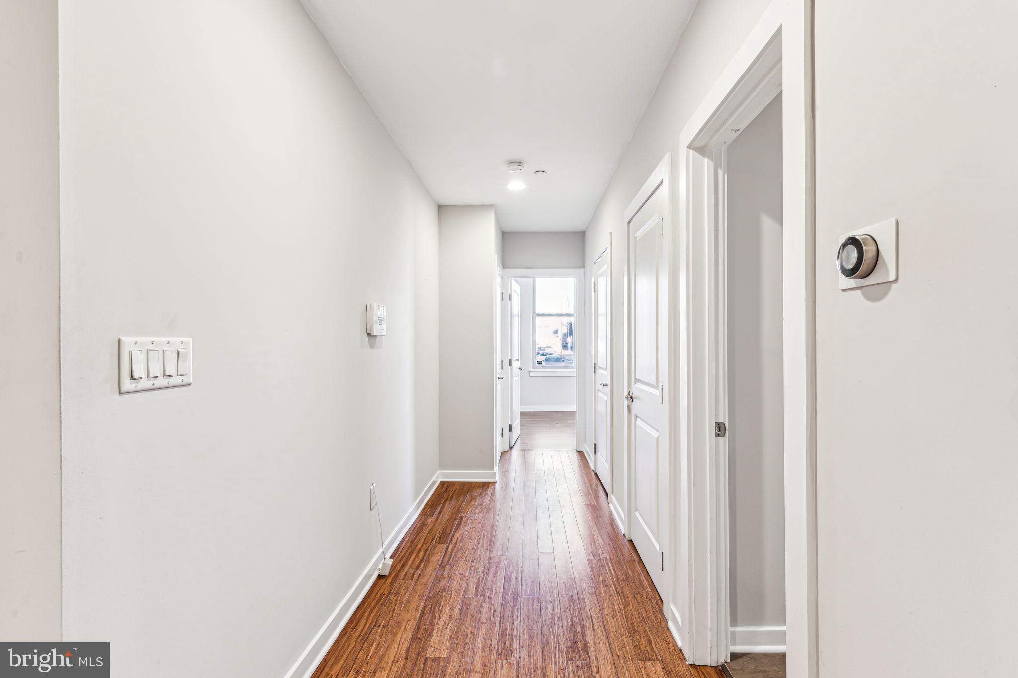 1418 Christian Street, Unit 1 Philadelphia, PA 19146 - Photo 7 of 28 a view of a hallway with wooden floor
