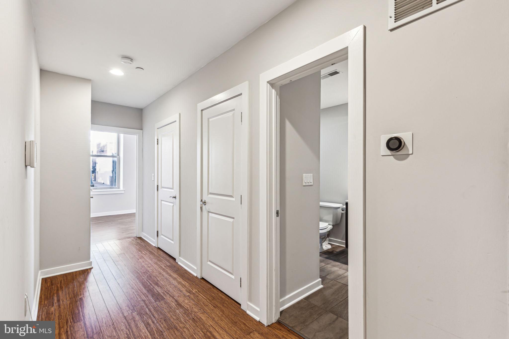 1418 Christian Street, Unit 1 Philadelphia, PA 19146 - Photo 8 of 28 a view of a hallway with wooden floor