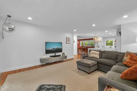 a living room with furniture and kitchen view