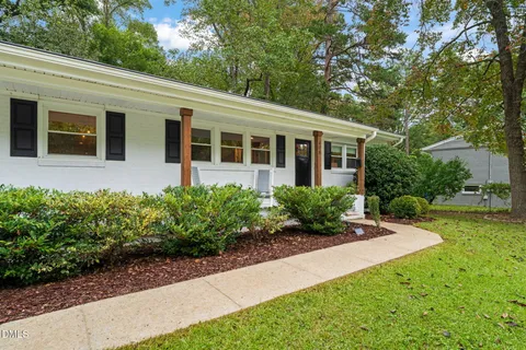 a front view of house with yard and green space