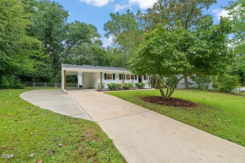 a view of house with outdoor space and garden