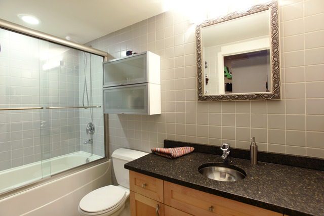333 South Desplaines Street, Unit 704 Chicago, IL 60661 - Photo 15 of 21 a bathroom with a granite countertop sink toilet and shower