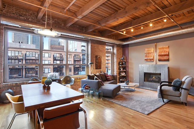 333 South Desplaines Street, Unit 704 Chicago, IL 60661 - Photo 5 of 21 a living room with furniture a fireplace and a table