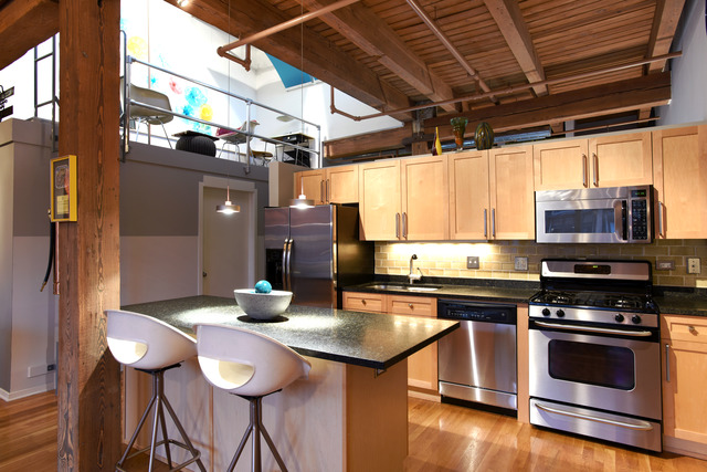 333 South Desplaines Street, Unit 704 Chicago, IL 60661 - Photo 8 of 21 a kitchen with stainless steel appliances a dining table and chairs