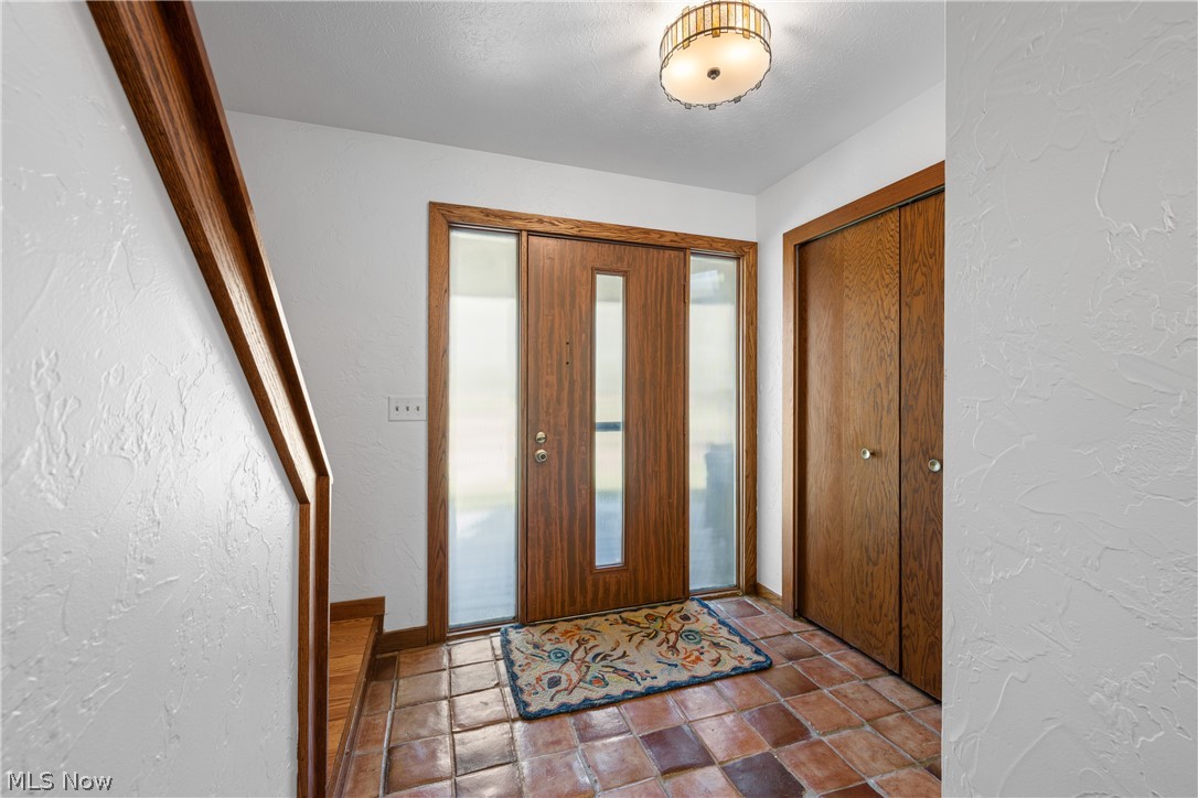 Bright and cheery foyer welcomes guests.  Double coat closet.