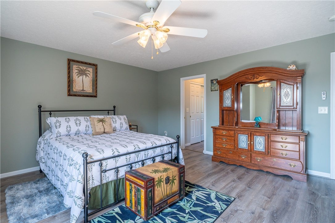 10765 Stone Ridge Way Harrison, OH 45030 - Photo 24 of 68 A tranquil bedroom retreat features durable flooring and a refreshing ceiling fan.