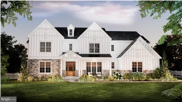 a front view of a house with a garden and trees