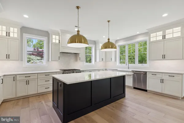 a kitchen with a sink window and cabinets