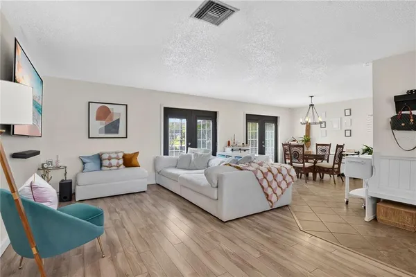 a living room with furniture a flat screen tv and a table