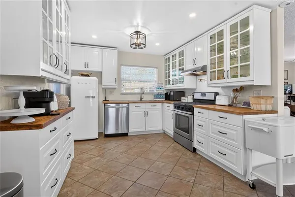 a view of a dining room with furniture and chandelier