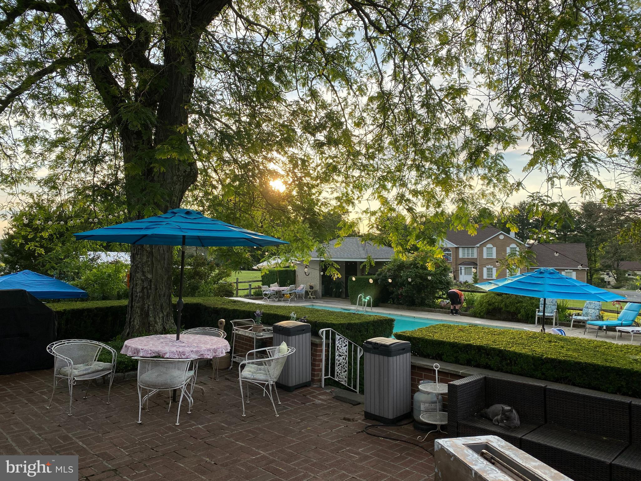 1591 Middletown Road Glen Mills, PA 19342 - Photo 37 of 55 an outdoor sitting area with furniture and umbrella