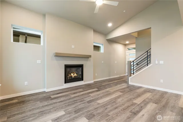 an empty room with wooden floor and a fireplace