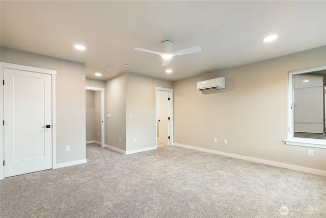 an empty room with windows and closet