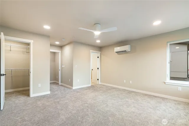 an empty room with closet and a window