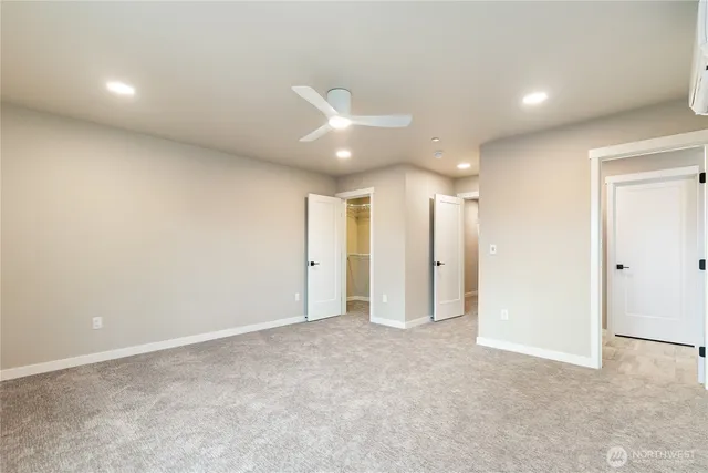 an empty room with a ceiling fan and a window