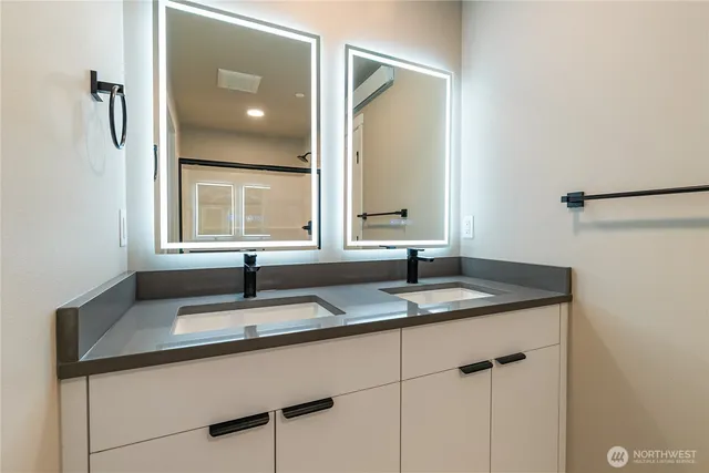 a bathroom with a granite countertop sink and a mirror