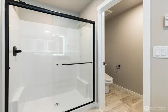 a bathroom with a glass shower door