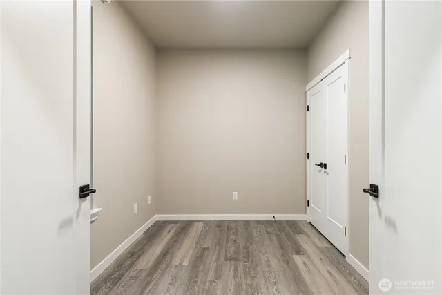a view of a room with wooden floor