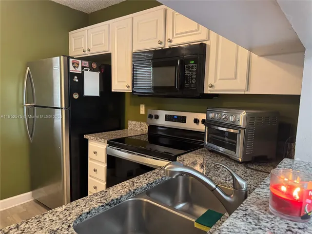 a kitchen with a stove and a refrigerator