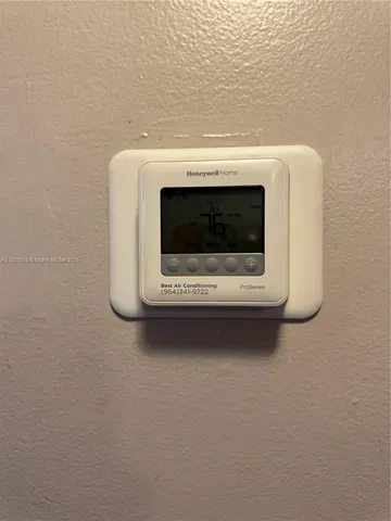 a view of a room with a chair and wooden floor