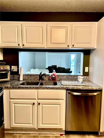 a kitchen with appliances cabinets and a counter top space