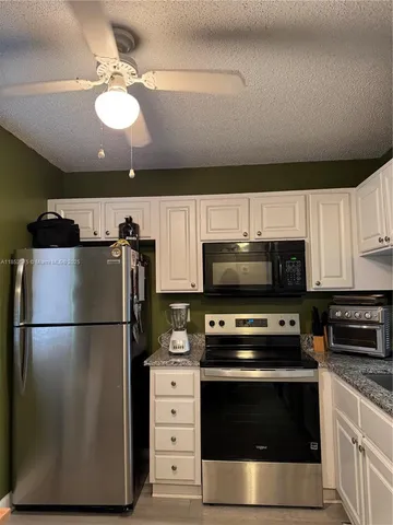 a kitchen with stainless steel appliances a stove a microwave and a refrigerator