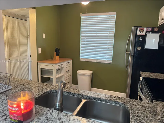 a view of a hallway with wooden floor and chandelier