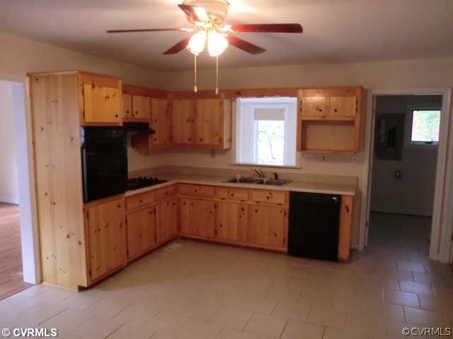 4318 Milsmith Road Chester, VA 23831 - Photo 8 of 12 a kitchen with a refrigerator and a sink