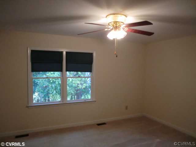 4318 Milsmith Road Chester, VA 23831 - Photo 10 of 12 an empty room with a window and a fan