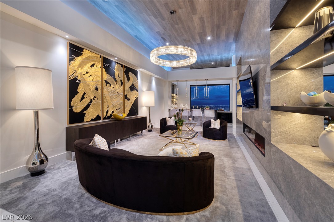 611 Cityview Ridge Drive Henderson, NV 89012 - Photo 18 of 66 Dramatic wood-paneled ceilings and integrated stone finishes define this sleek, open living area.
