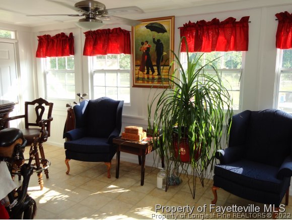 1013 Myra Road Raeford, NC 28376 - Photo 18 of 25 a living room with furniture a window and a flat screen tv