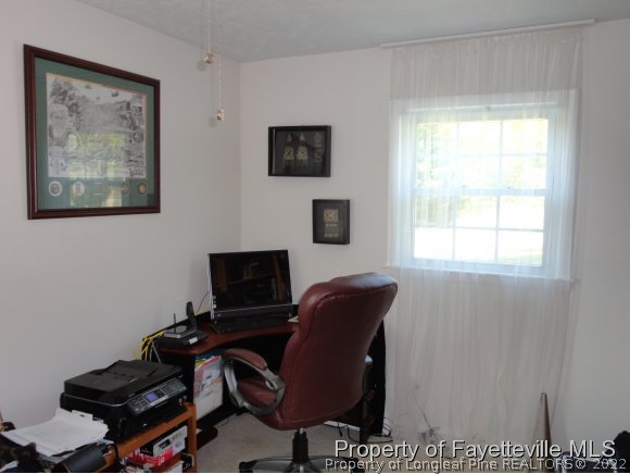 1013 Myra Road Raeford, NC 28376 - Photo 23 of 25 a view of a workspace with furniture and a window