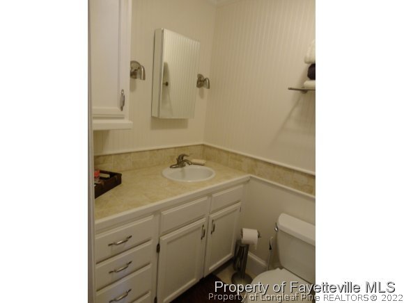1013 Myra Road Raeford, NC 28376 - Photo 24 of 25 a bathroom with a sink and a toilet