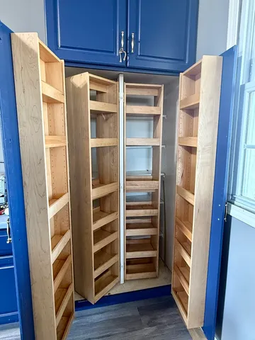 a view of walk in closet with empty racks