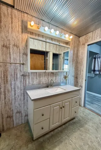 a bathroom with a double vanity sink and mirror