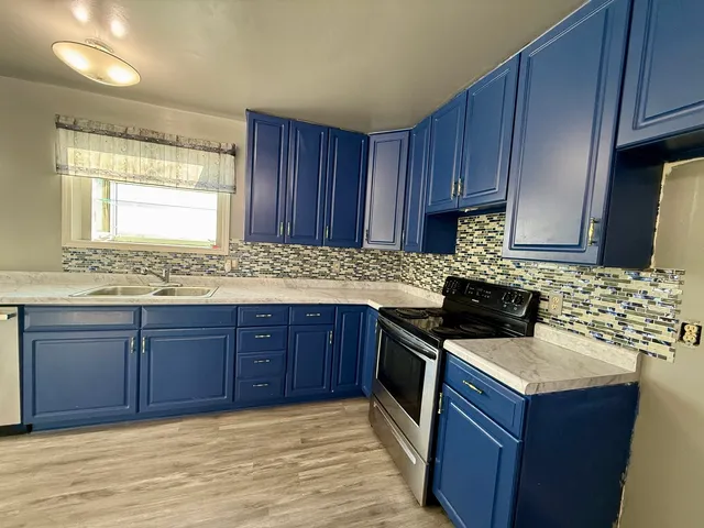 a kitchen with stainless steel appliances granite countertop wooden cabinets a sink and dishwasher