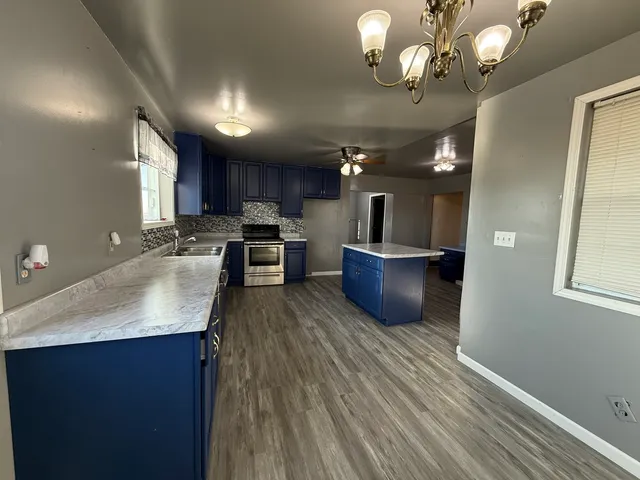 a kitchen with a sink a microwave and cabinets