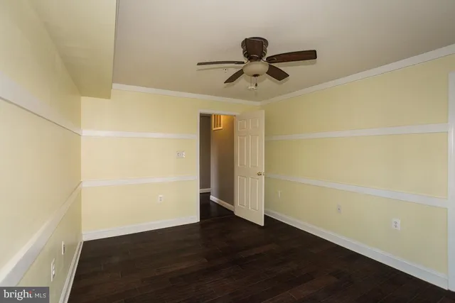 a view of a room with wooden floor and window