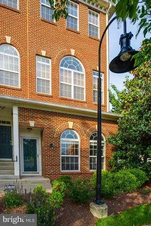 front view of a brick house with a small yard