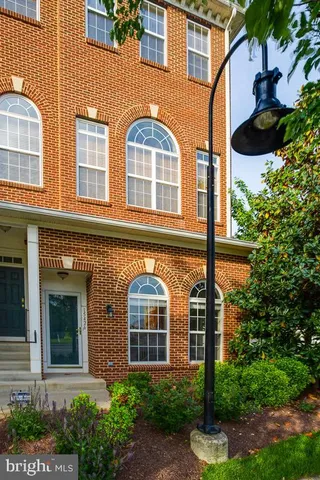 front view of a brick house with a small yard