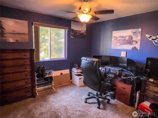 a view of workspace with windows recliner chair
