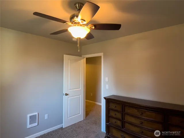 a view of room with a ceiling fan
