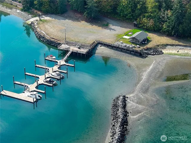 an aerial view of a house with a garden and lake view