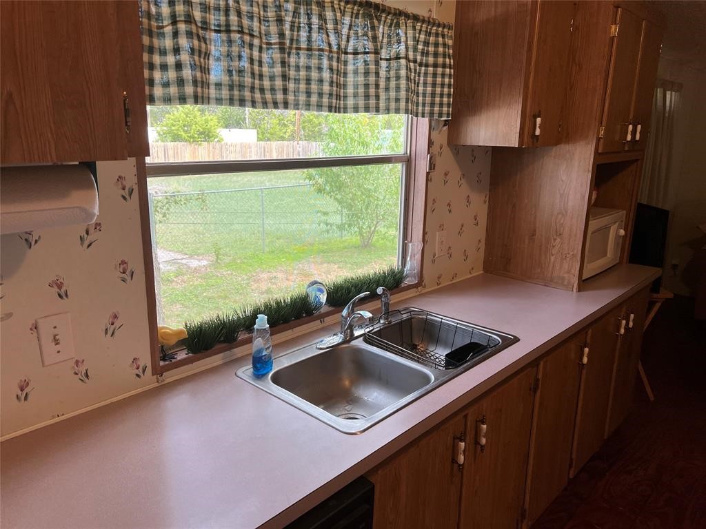 15608 Checotah Drive Austin, TX 78734 - Photo 22 of 38 a kitchen with a sink and a large window