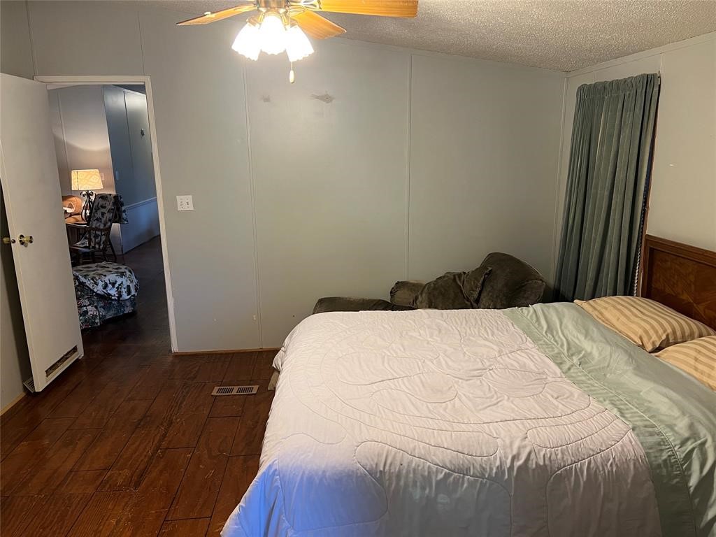15608 Checotah Drive Austin, TX 78734 - Photo 23 of 38 a bedroom with a bed and a chandelier