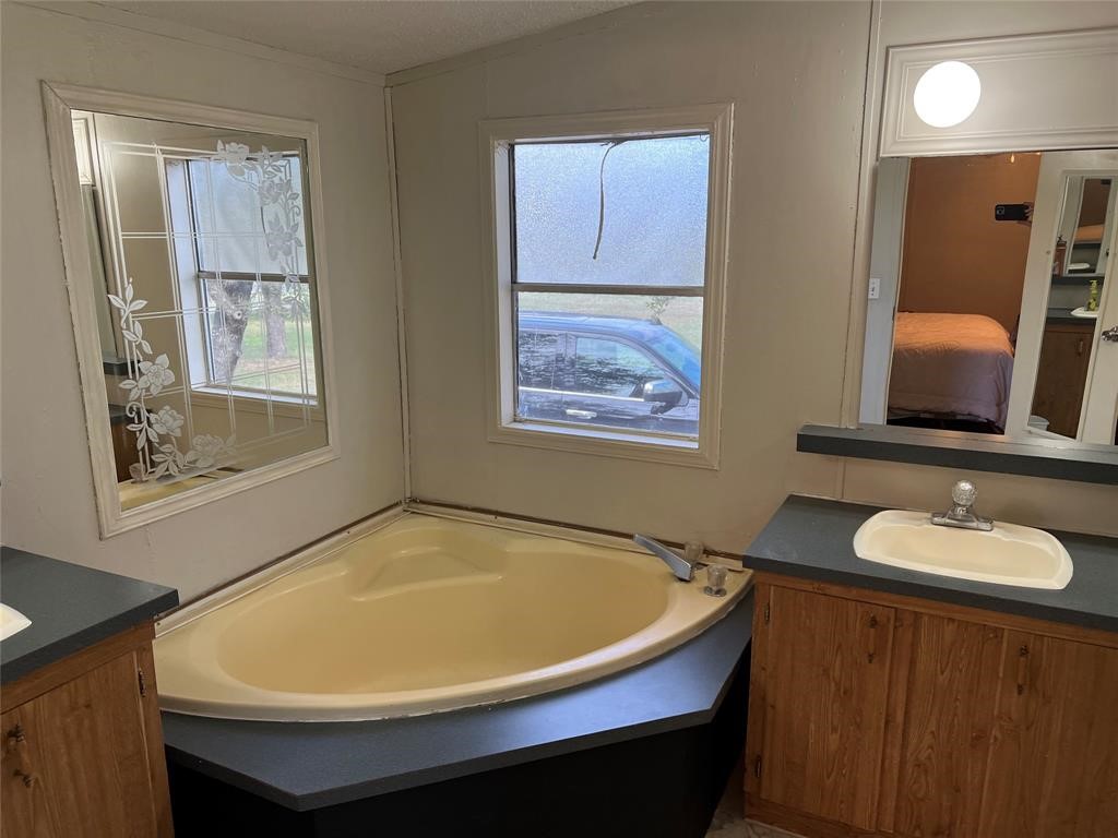 15608 Checotah Drive Austin, TX 78734 - Photo 26 of 38 a bathroom with a sink and a mirror