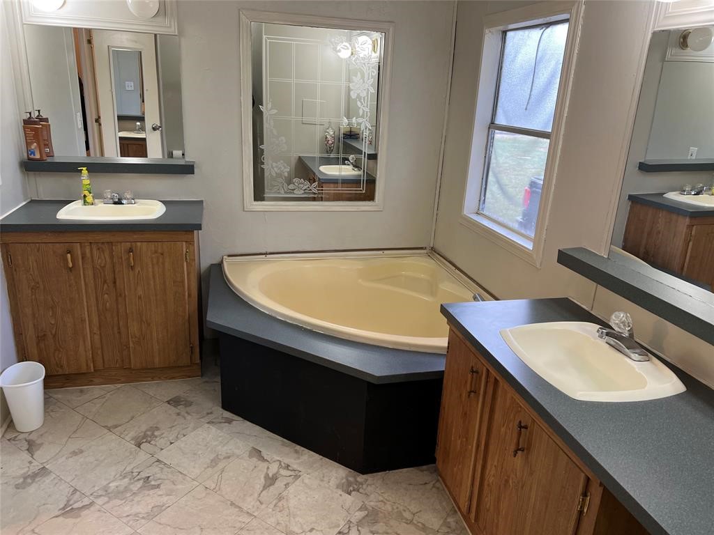 15608 Checotah Drive Austin, TX 78734 - Photo 27 of 38 a bathroom with a sink and a mirror
