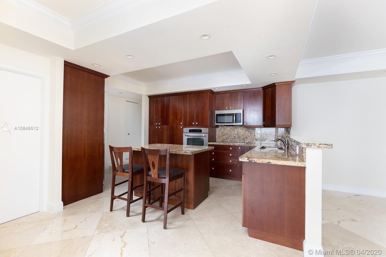 2333 Brickell Avenue, Unit TSD Miami, FL 33129 - Photo 13 of 44 a kitchen with stainless steel appliances granite countertop a stove top oven a sink dishwasher a dining table and chairs with wooden floor