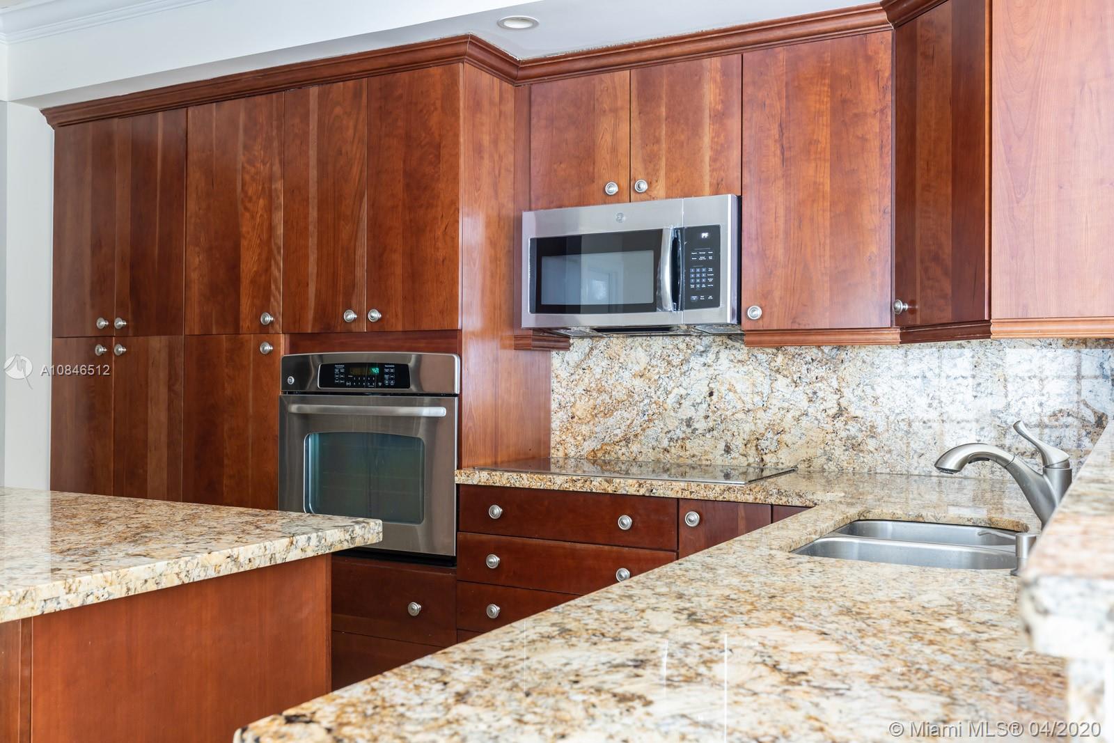 2333 Brickell Avenue, Unit TSD Miami, FL 33129 - Photo 14 of 44 a kitchen with kitchen island sink cabinets and appliances