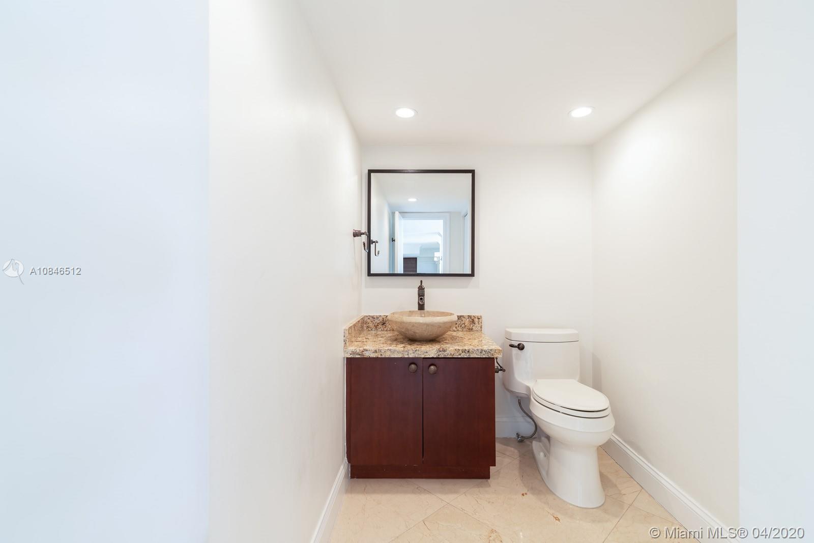 2333 Brickell Avenue, Unit TSD Miami, FL 33129 - Photo 36 of 44 a bathroom with a granite countertop toilet and sink
